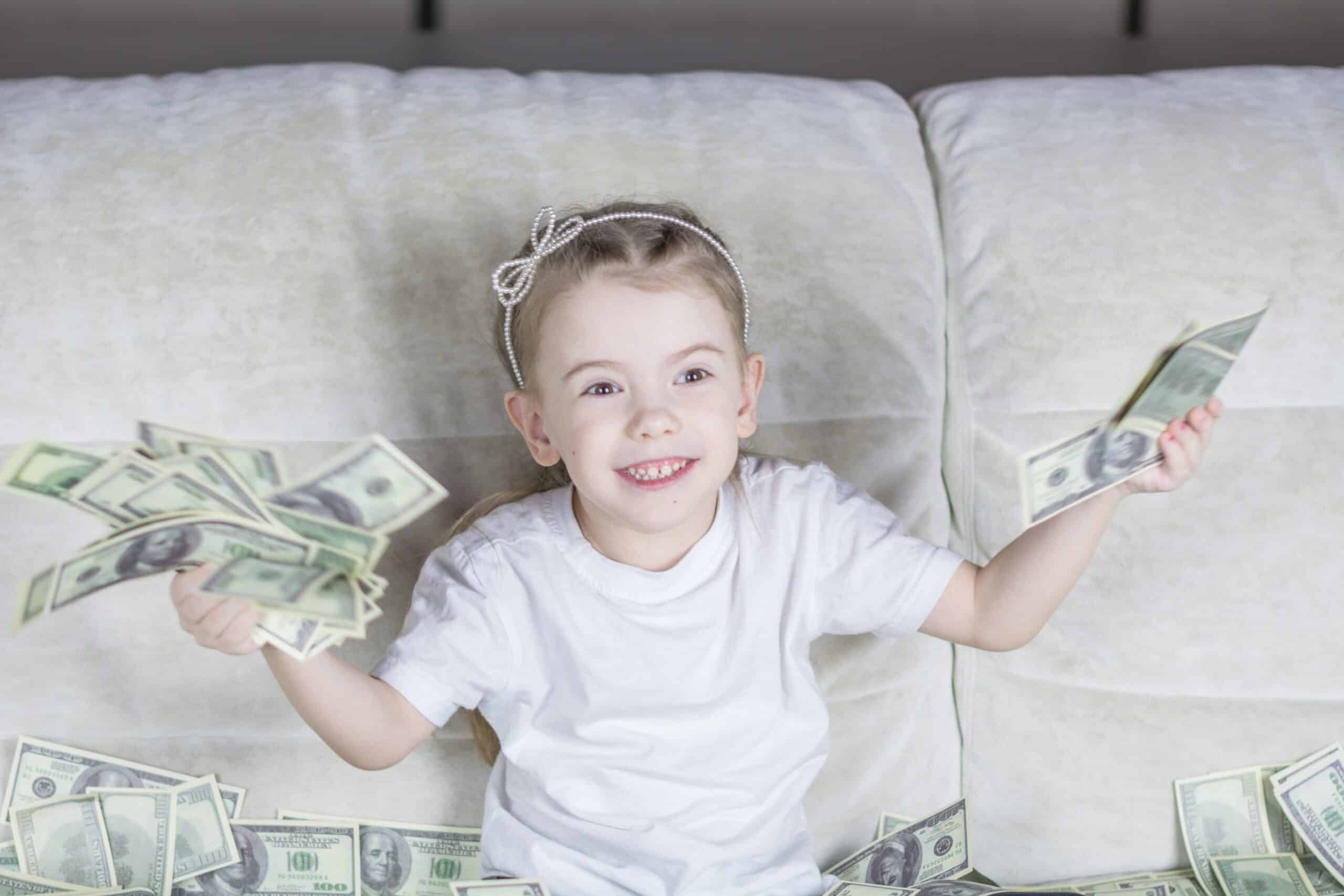 Happy child holding money in hands